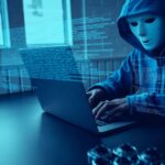 Asian people hacker wear a mask using a laptop cyber attack.